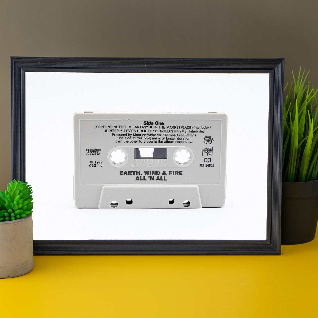 Modern art photo of the cassette of "Earth, Wind & Fire All 'N All" displayed in your office